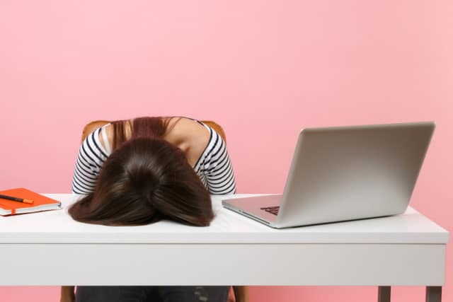 Frustrated woman at laptop